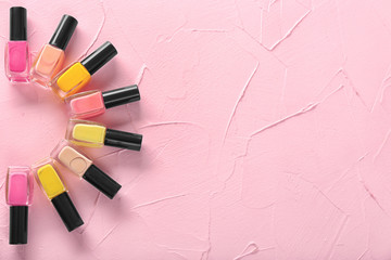 Obraz premium Bottles of nail polishes on color background