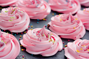Homemade marshmallow, fluffy dessert zephyr, pink swirl meringue with colorful sugar sprinkles
