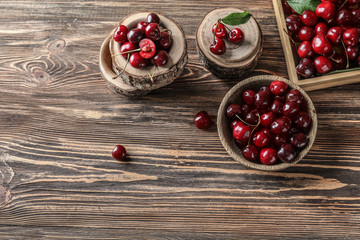 Composition with ripe cherry on wooden background