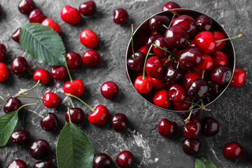 Bowl with fresh ripe cherry on grunge background