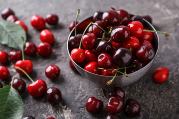 Bowl with fresh ripe cherry on grunge background