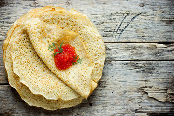 Pancakes with red caviar on plate russian cuisine maslenitsa flat lay top view