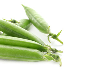 Pods with fresh green peas on white background