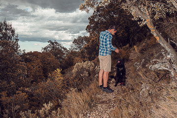 Man with his dog in the mountains