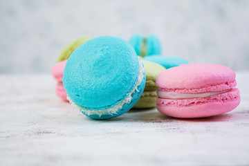 Delicious colorful macaron cakes on wooden background