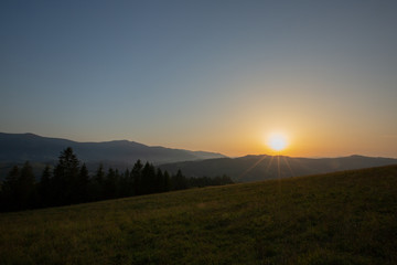 Naklejka na ściany i meble Mountain range on the background of the sunset