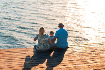 Grandparents with grandson enjoying time together by the lake.