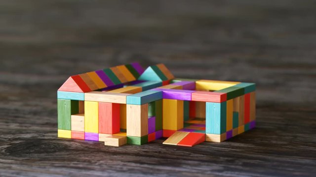 Toy House Being Built Out Of Wooden Blocks Timelapse. Construction Development.