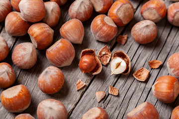 Heap Hazel and two nuts with  broken shell on an old wooden table