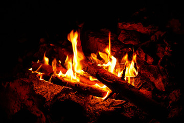 Flame on a black background in natural conditions at night.