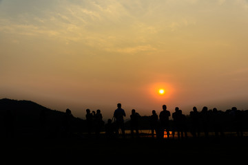 Fototapeta na wymiar Group of tourist photographers shooting beautiful view of sunse