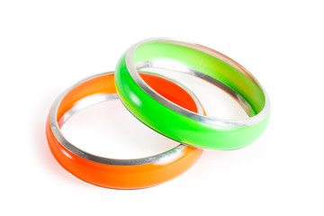 Two plastic stylish women bracelets - green and orange isolated on white