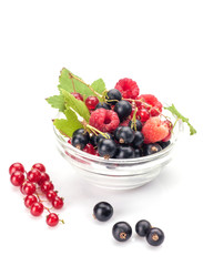 Mixed berries in glass bowl isolated on white background