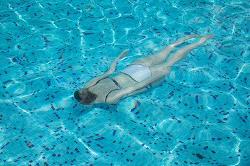 Young girl swimming in the pool