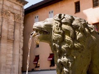 detail on the lion's head of the fountain in downtown Annecy, france