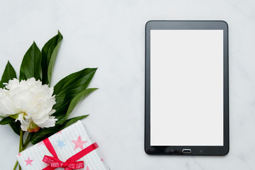Composition with flowers and tablet pc on white background. Mock up for your design. Flat lay.