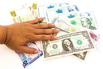 Man hand on the multi currency banknotes