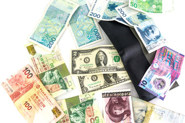 Obraz na płótnie Canvas Multi currency banknotes with a men's wallet isolated