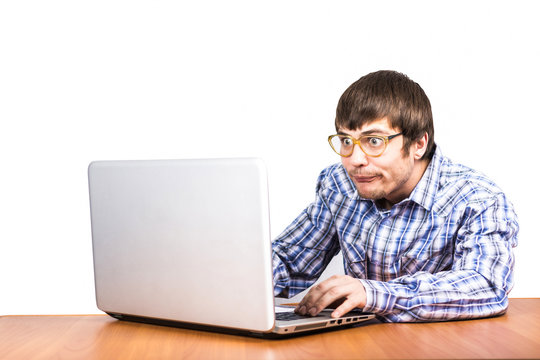 guy nerd works behind laptop