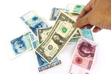 Hand of man is picking up the US dollar banknote