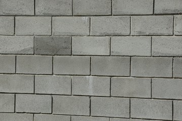 gray stone texture of bricks in the wall of a building