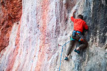 A man climbs the rock.