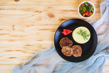 Puree potatoes with cutlets on wooden background