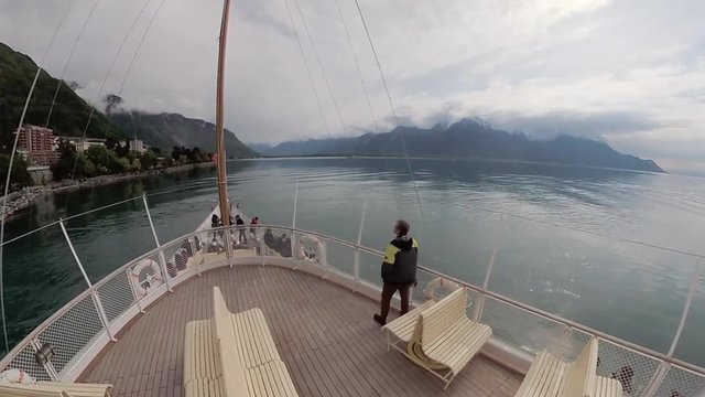 Tourist ship sails along the Lake Geneva to the Chillon Castle.
