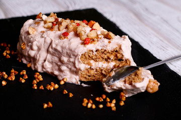 Sweet slice of walnut carrot cake on white plate