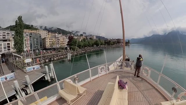Tourist ship sails along the Lake Geneva to the Chillon Castle.