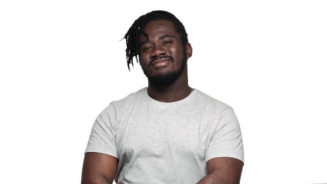 Portrait of handsome muscular african man wearing pigtails and mustache gesturing at camera index finger meaning hey you, isolated over white background slow motion. Concept of emotions