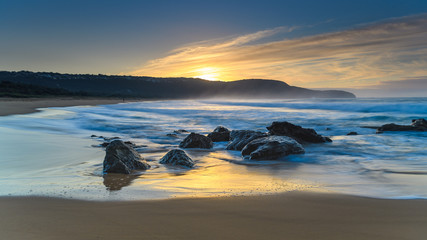 Fototapeta na wymiar Soft Blue Rocky Sunrise Seascape