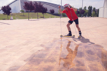 A young man cross-country skiing with rollerski