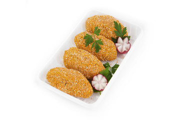 Freshly frozen semi-finished products. Cutlets from tender meat of chicken in a cover made of biscuits. The product is packed on plastic potdtons. Isolate on white background.