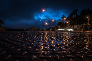 Fototapeta premium Urban night landscape with blurry car headlights