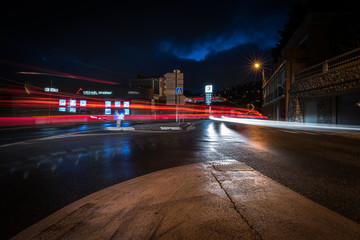 Urban night landscape with blurry car headlights