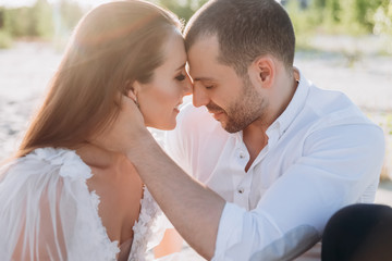 Fototapeta premium beautiful tender couple on beach with backlit