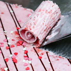 Thai roll ice cream is made by hand on the freezer. Sweet dessert made from natural berries and ingredients. The process of making food.