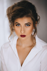   Portrait of beautiful woman with makeup in fashion clothes