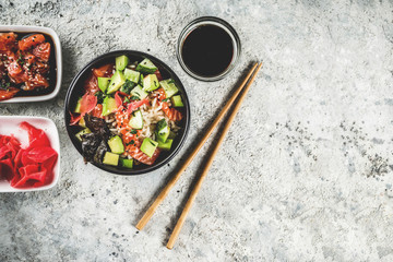 Asian trendy food, sushi poke bowl with cucumber, salmon, avocado, Black and White Sesame Seeds