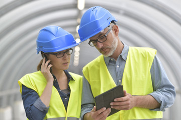 Industrial engineers working together using tablet