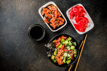 Asian trendy food, sushi poke bowl with cucumber, salmon, avocado, Black and White Sesame Seeds
