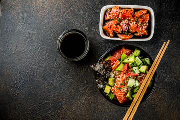Asian trendy food, sushi poke bowl with cucumber, salmon, avocado, Black and White Sesame Seeds