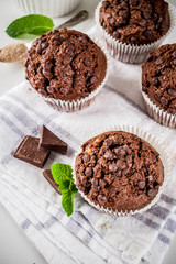 Home baked mint and chocolate muffins with mint tea, white marble background copy space