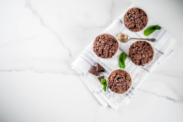 Home baked mint and chocolate muffins with mint tea, white marble background copy space