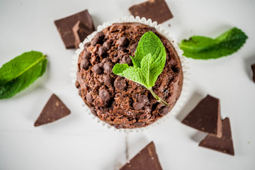 Home baked mint and chocolate muffins with mint tea, white marble background copy space