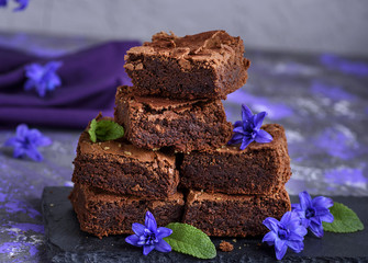 chocolate pieces of brownie pie are stacked