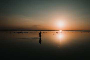 .Young man on vacation in the Gili Islands enjoying a colorful sunset in Indonesia. Photograph and vacation.