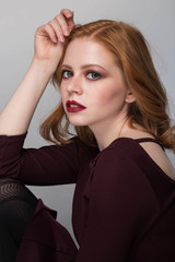 Fototapeta premium portrait of a beautiful young woman with elegant long red shiny hair