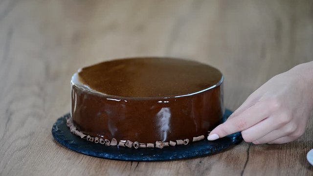 Process of creating delicious dessserts. Decorating chocolate mousse cake.